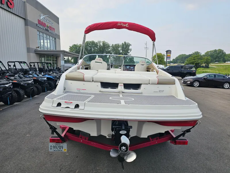 Slide: The Image of 2007 Sea Ray 210 Select boat with red canopy, parked outside dealership. - 5