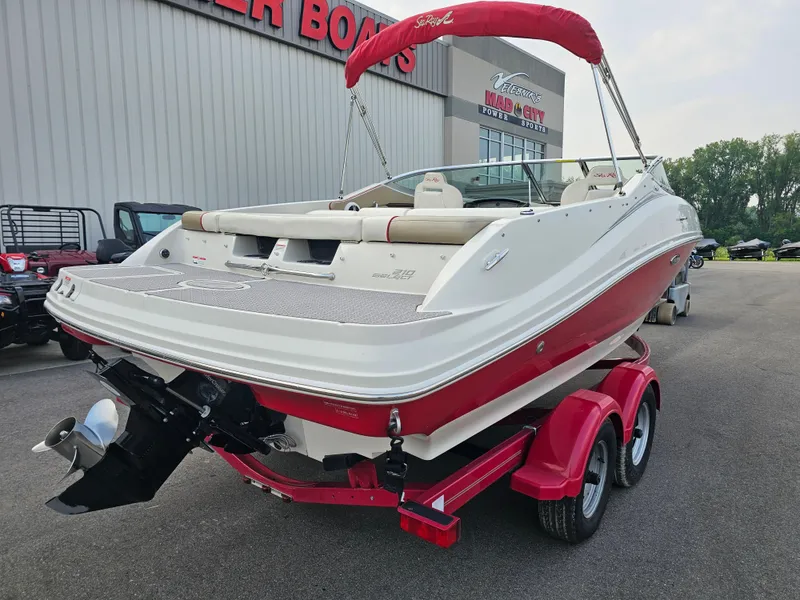 Slide: The Image of 2007 Sea Ray 210 Select boat on red trailer, parked outside dealership. - 6