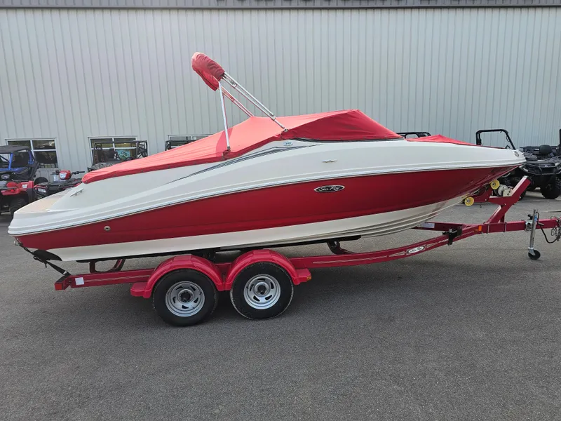 Slide: The Image of 2007 Sea Ray 210 Select boat with red cover on trailer, parked outdoors. - 7