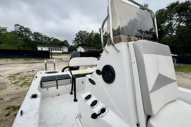 Slide: The Image of 2019 Key Largo 206 Bay boat with seating and console, parked outdoors. - 9