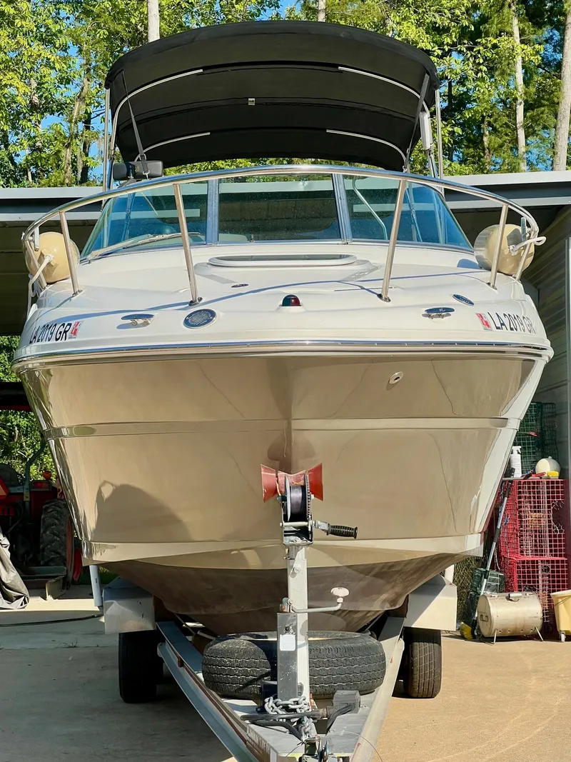 Slide: The Image of 2009 Sea Ray 240 Sundancer boat on trailer, parked outdoors. - 1
