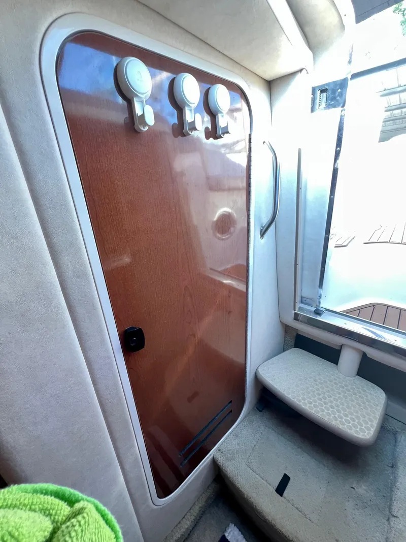 Slide: The Image of Interior cabin door of 2009 Sea Ray 240 Sundancer boat with wooden finish. - 13