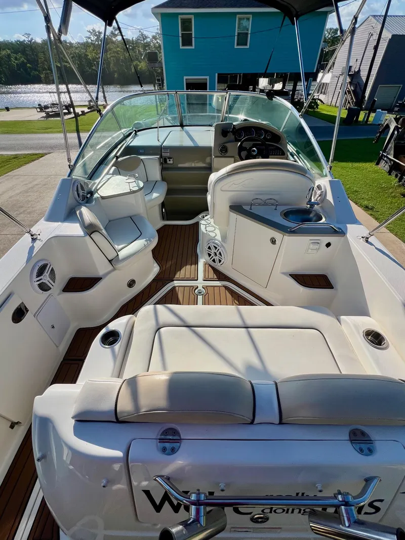 Slide: The Image of 2009 Sea Ray 240 Sundancer boat interior with seating, steering, and deck view. - 4