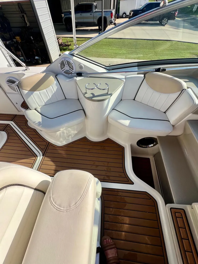 Slide: The Image of Interior of 2009 Sea Ray 240 Sundancer with white seating and wood flooring. - 5