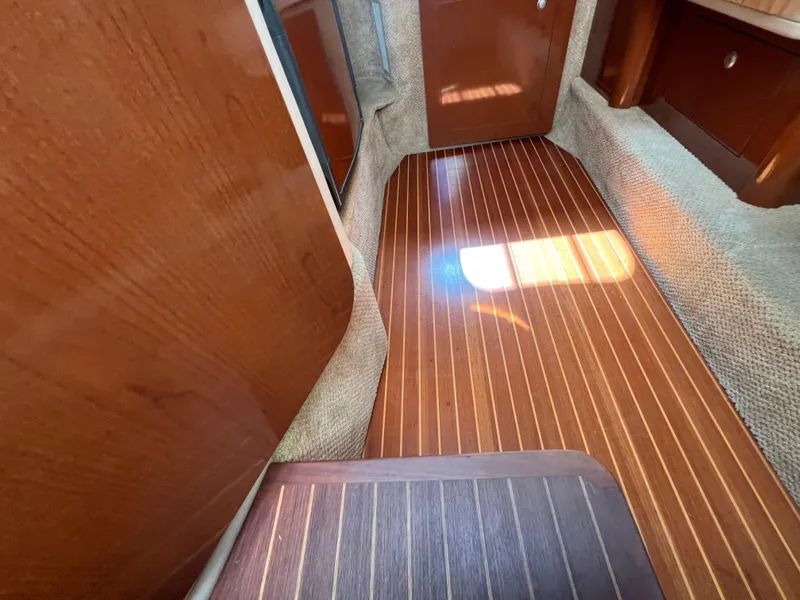 Slide: The Image of 2008 Sea Ray 290 Amberjack boat hull on trailer by water. - 21