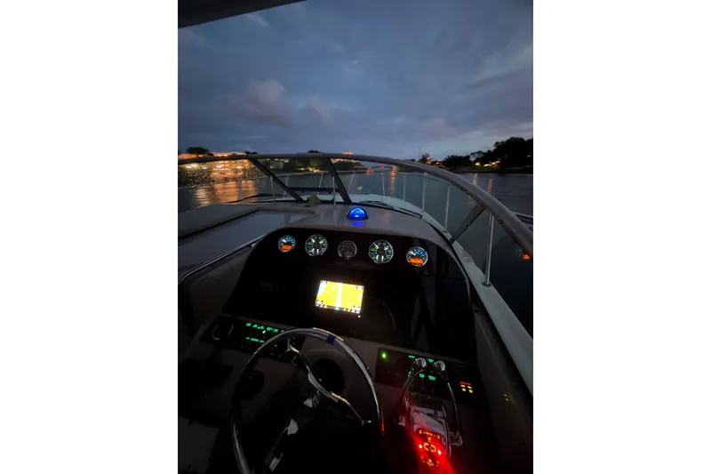 Slide: The Image of Cockpit view of 2008 Sea Ray 290 Amberjack boat at dusk on the water. - 24