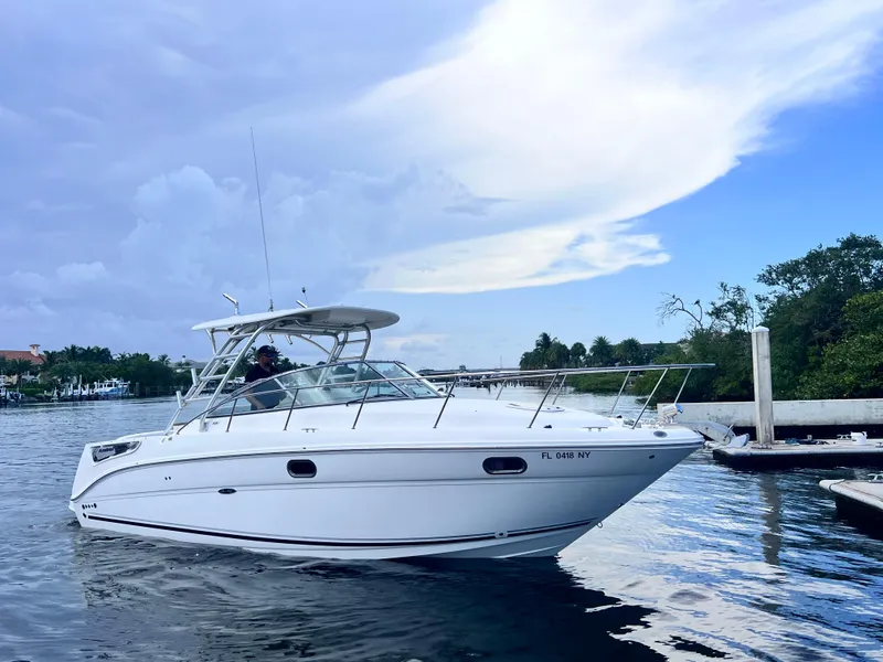 Slide: The Image of 2008 Sea Ray 290 Amberjack boat on calm water under a cloudy sky. - 7