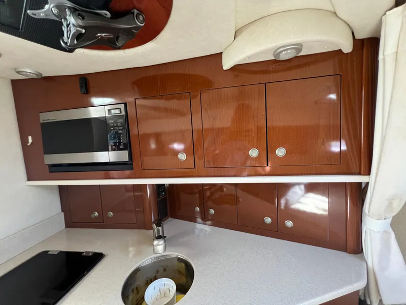 Slide: The Image of 2008 Sea Ray 290 Amberjack boat on calm water under a cloudy sky. - 8