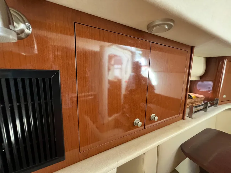 Slide: The Image of 2008 Sea Ray 290 Amberjack boat cruising on a calm waterway under a cloudy sky. - 9