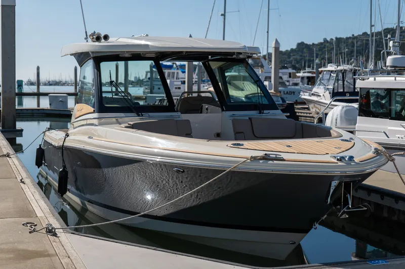 Slide: The Image of 2024 Chris-Craft Calypso 32 boat docked in marina, showcasing sleek design and luxury features. - 15