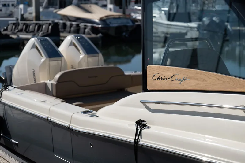 Slide: The Image of 2024 Chris-Craft Calypso 32 boat docked, showcasing sleek design and dual engines. - 16