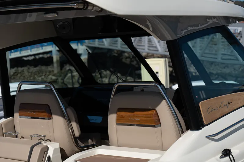 Slide: The Image of 2024 Chris-Craft Calypso 32 boat interior with elegant seating and wood accents. - 18