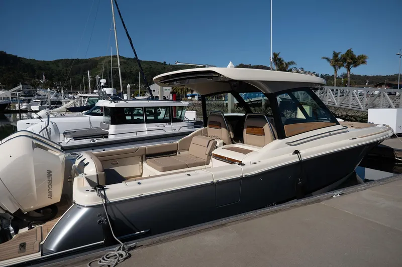 Slide: The Image of 2024 Chris-Craft Calypso 32 boat docked at marina with Mercury engines. - 20