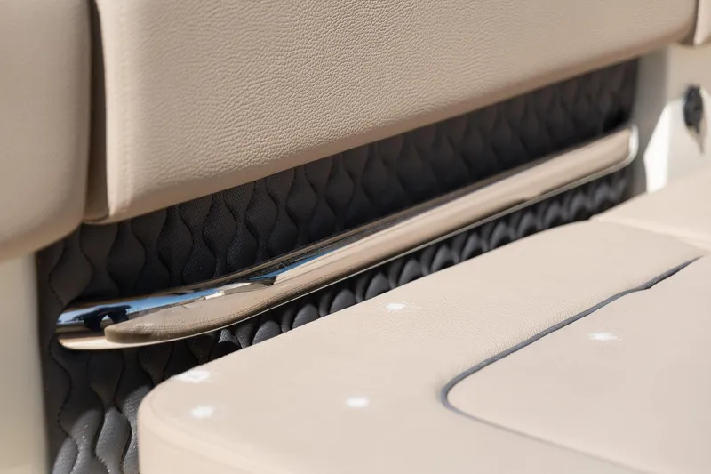 Slide: The Image of 2024 Chris-Craft Calypso 32 interior detail with beige upholstery and chrome accents. - 21