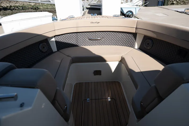 Slide: The Image of 2024 Chris-Craft Calypso 32 boat interior with luxurious seating and wood flooring. - 23