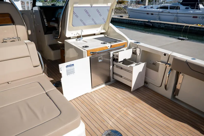 Slide: The Image of 2024 Chris-Craft Calypso 32 boat interior with kitchenette and seating area. - 24