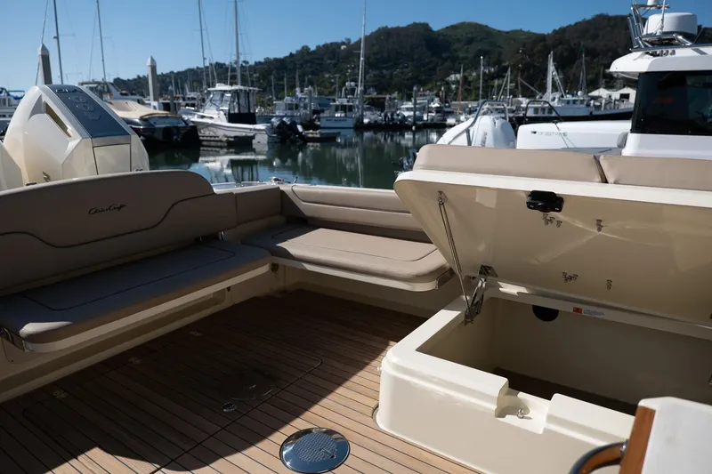 Slide: The Image of 2024 Chris-Craft Calypso 32 boat interior with open storage, docked at marina. - 27