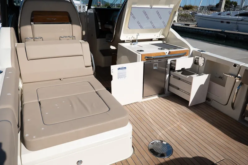 Slide: The Image of 2024 Chris-Craft Calypso 32 boat interior with seating, kitchenette, and storage. - 28