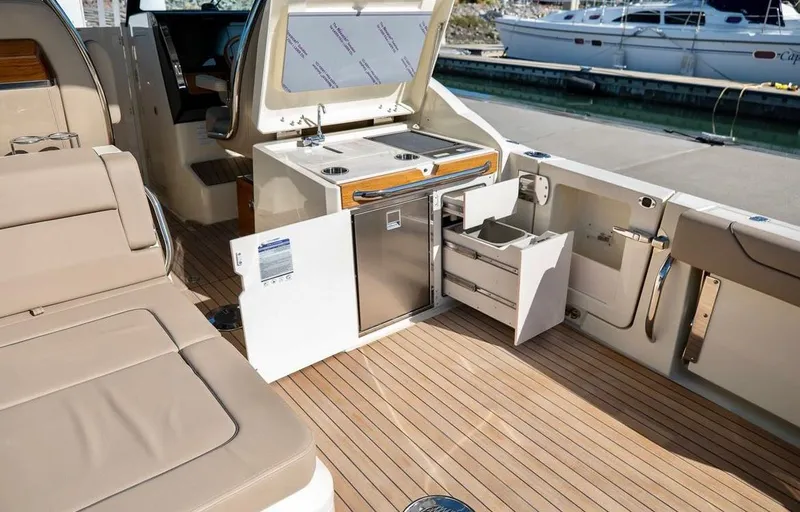 Slide: The Image of 2024 Chris-Craft Calypso 32 boat interior with open storage compartments and seating. - 3
