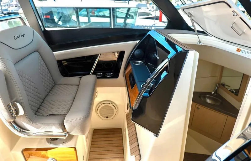 Slide: The Image of 2024 Chris-Craft Calypso 32 interior helm station with luxurious seating and modern controls. - 5