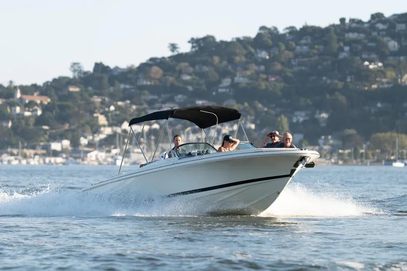 The Image of 2023 Chris-Craft Launch 27 boat cruising on water with scenic background. - 0