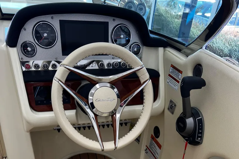 Slide: The Image of 2023 Chris-Craft Launch 27 dashboard with steering wheel and control panel. - 3
