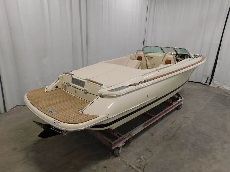 Slide: The Image of 2023 Chris-Craft Launch 27 boat in showroom, rear view. - 5