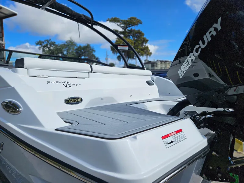 Slide: The Image of 2026 Monterey M-205 boat with Mercury engine, rear view, white exterior, outdoor setting. - 10