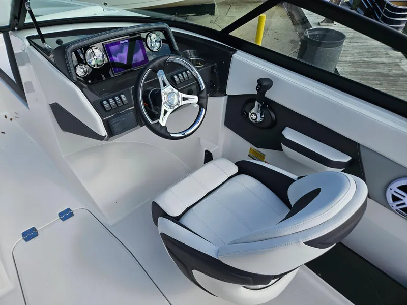 Slide: The Image of 2026 Monterey M-205 boat cockpit with modern steering wheel and dashboard controls. - 14