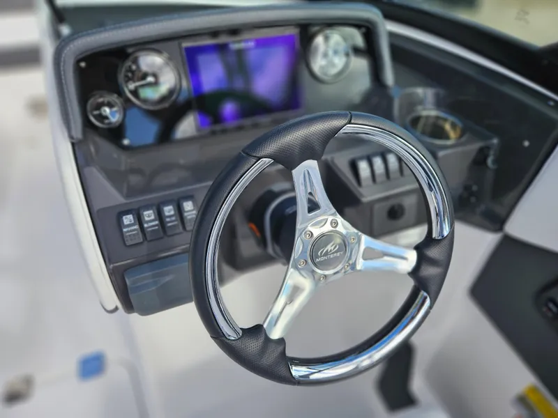 Slide: The Image of Steering wheel and dashboard of 2026 Monterey M-205 boat, featuring modern controls and display. - 15