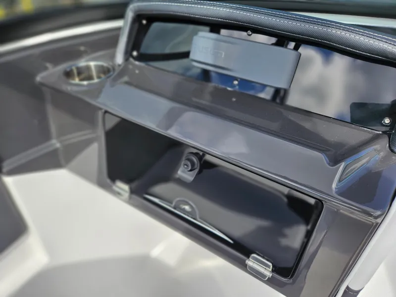 Slide: The Image of Dashboard of 2026 Monterey M-205 boat with storage compartment and cup holder. - 19