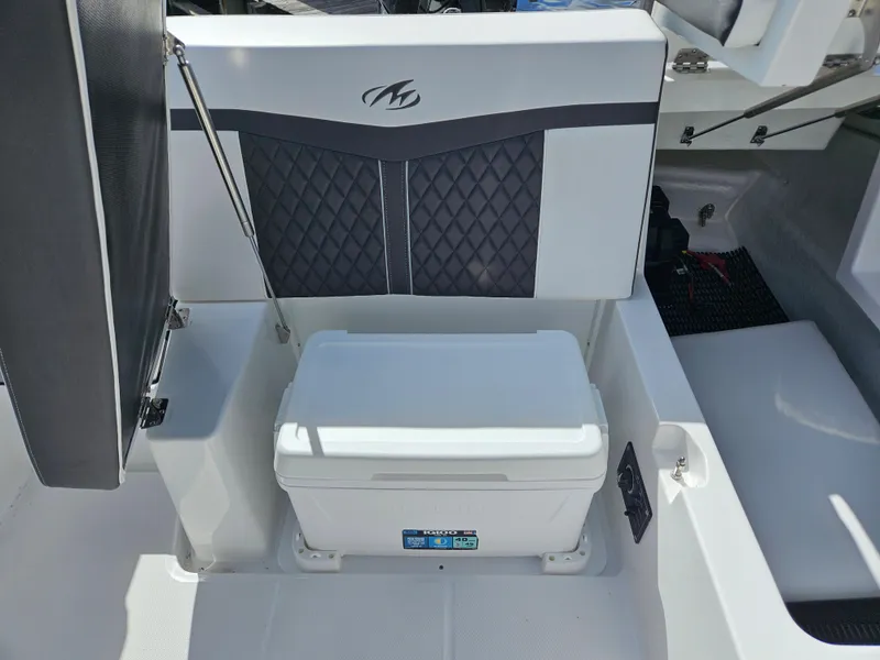 Slide: The Image of 2026 Monterey M-205 boat interior with cushioned seating and storage compartment. - 24