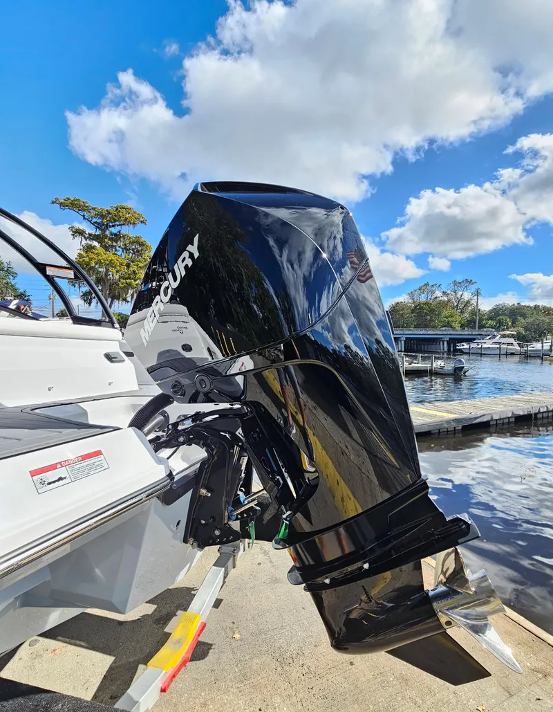 Slide: The Image of 2026 Monterey M-205 boat with Mercury outboard motor by a sunny lakeside. - 7