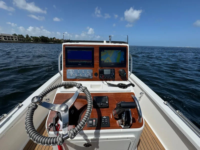 Slide: The Image of 2024 Dragonfly 21 Spanish Wells boat dashboard with navigation equipment on open water. - 10