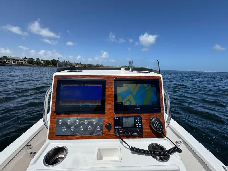 Slide: The Image of Control panel of 2024 Dragonfly 21 Spanish Wells boat on open water. - 11