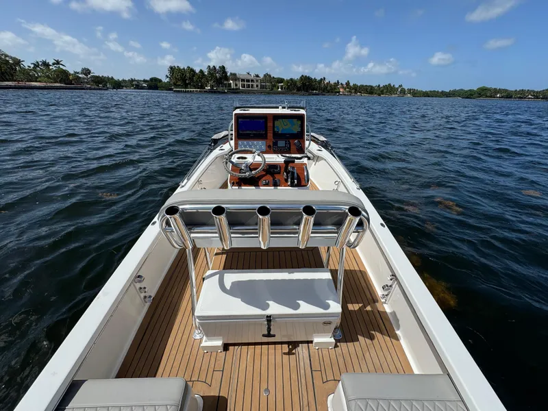 Slide: The Image of 2024 Dragonfly 21 Spanish Wells boat on water, featuring sleek design and advanced navigation system. - 14