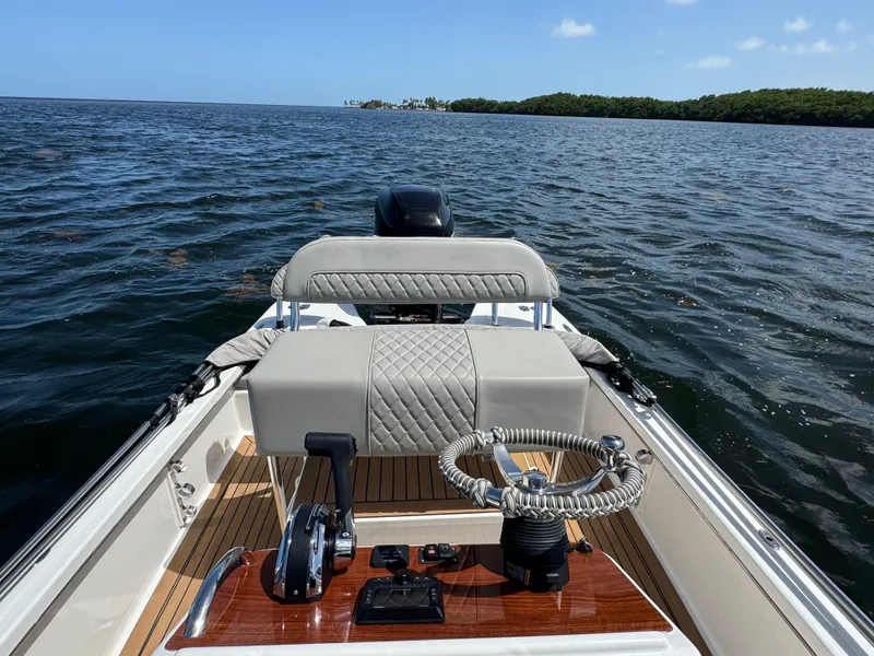 Slide: The Image of 2024 Dragonfly 21 Spanish Wells boat on open water, featuring elegant steering and seating. - 15