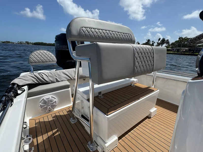 Slide: The Image of 2024 Dragonfly 21 Spanish Wells boat interior with cushioned seating and wooden deck. - 17