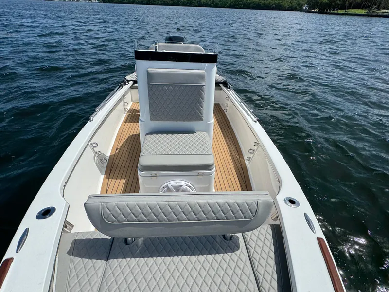 Slide: The Image of 2024 Dragonfly 21 Spanish Wells boat interior with quilted seating on open water. - 18