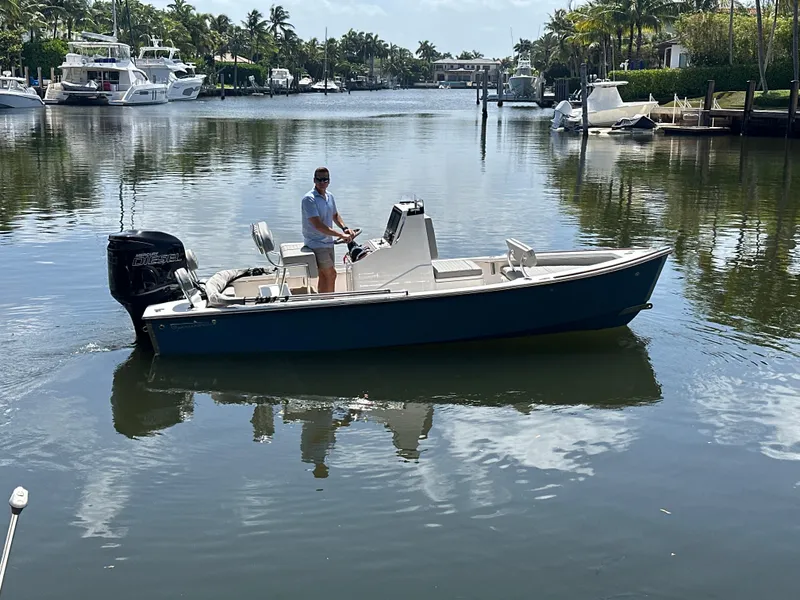 Slide: The Image of 2024 Dragonfly 21 Spanish Wells boat cruising on a calm waterway. - 2