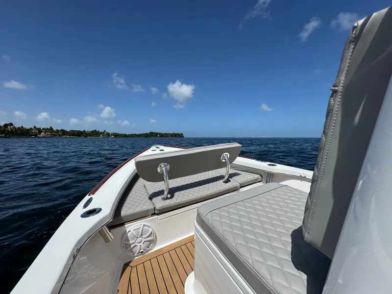 Slide: The Image of 2024 Dragonfly 21 Spanish Wells boat interior with cushioned seating on open water. - 20