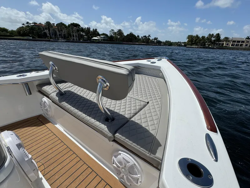 Slide: The Image of 2024 Dragonfly 21 Spanish Wells boat interior with cushioned seating and scenic water view. - 21