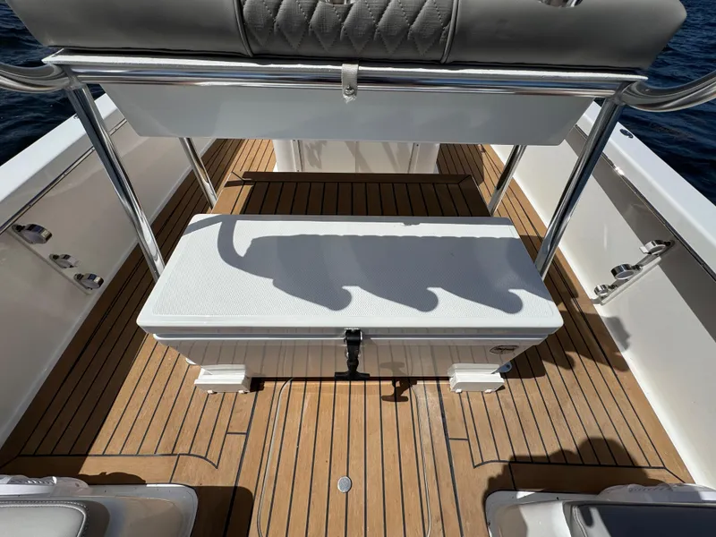 Slide: The Image of 2024 Dragonfly 21 Spanish Wells boat interior with wooden deck and seating. - 28