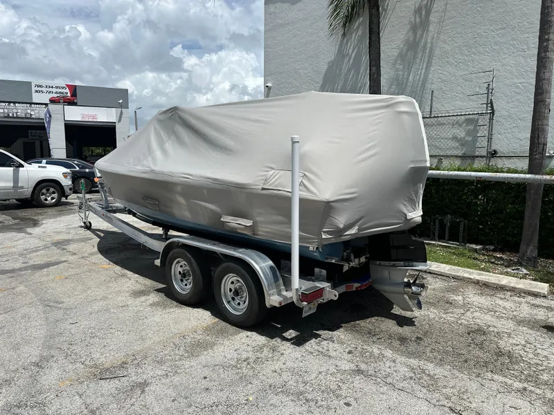 Slide: The Image of Covered 2024 Dragonfly 21 Spanish Wells boat on trailer in parking lot. - 30