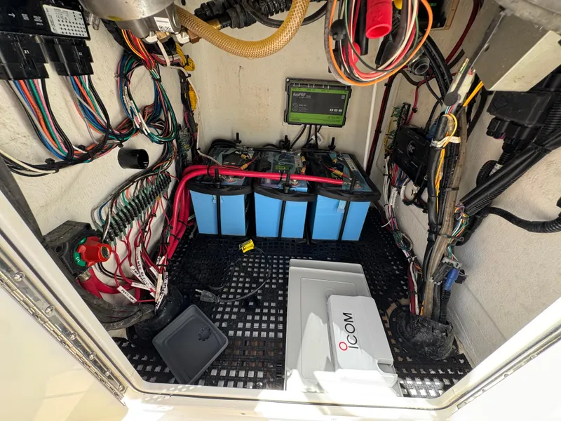 Slide: The Image of Electrical compartment of 2024 Dragonfly 21 Spanish Wells boat with batteries and wiring. - 32