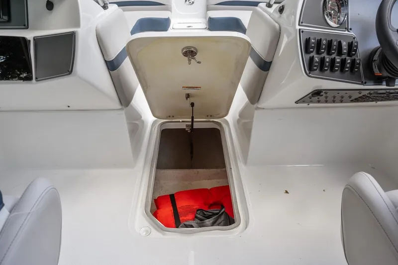 Slide: The Image of 2025 Hurricane SunDeck 217 OB boat storage compartment with life jacket inside. - 11