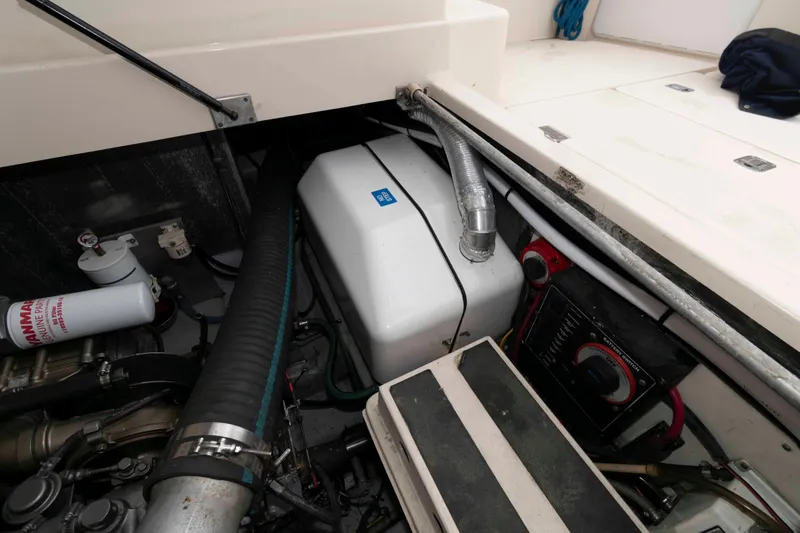 Slide: The Image of Engine compartment of 2004 Mainship 34 Pilot Rum Runner II with visible components and wiring. - 16