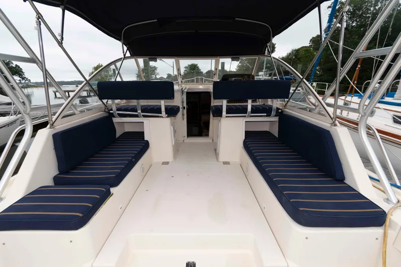 Slide: The Image of 2004 Mainship 34 Pilot Rum Runner II boat interior with blue seating and canopy. - 6