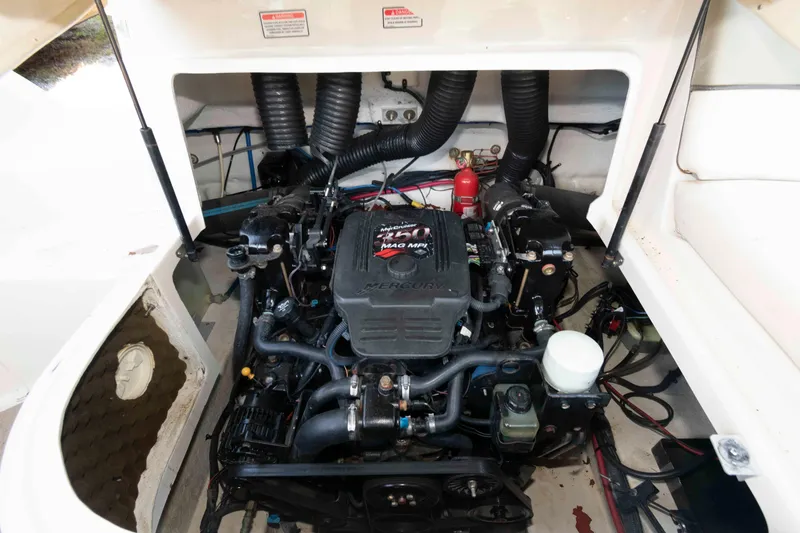 Slide: The Image of Engine compartment of a 2006 Sea Ray 240 Sundeck boat, featuring a Mercury engine. - 13