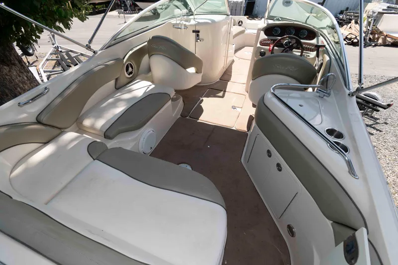 Slide: The Image of 2006 Sea Ray 240 Sundeck interior with spacious seating and modern dashboard. - 3